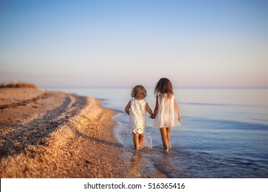 Two Little Girls Are On The Beach