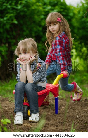 Similar – children playing in the sand, having a conversation over sand toys