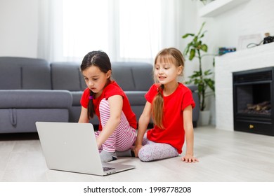 Two Little Girls Sitting In Front Of A Laptop And Laughing, Close-up, Positive Emotions, Entertainment On The Internet For Children