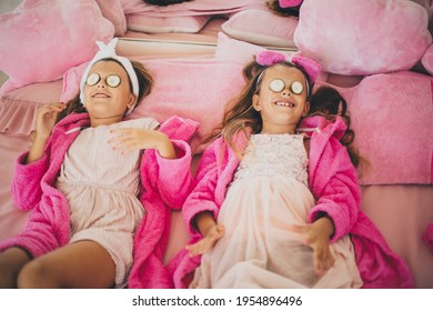 Two little girls in spa salon having a face treatment. 