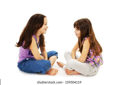 Two Little Girls Talking. Isolated On White Background 