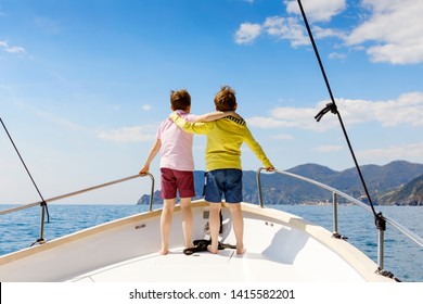 Two Little Kid Boys, Best Friends Enjoying Sailing Boat Trip. Family Vacations On Ocean Or Sea On Sunny Day. Children Smiling. Brothers, Schoolchilden, Siblings, Best Friends Having Fun On Yacht.
