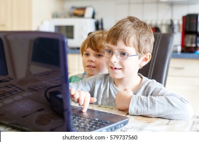 Two Little Kids Boys Playing Online Chess Board Game On Computer. Children, Siblings, Friends And Twins Having Fun With Learning On Pc. Education Concept.