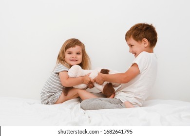 Two little kids, brother and sister fighting over a toy. the conflict between children. chelter in place. quarantine. conflict
