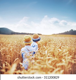 Two Little Kids Walking On The Wheat Field