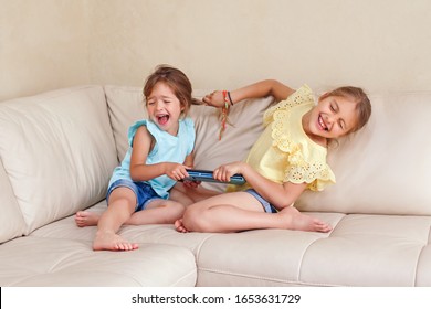 Two Little Mad Angry Girls Sisters Having Fight At Home. Friends Girls Can Not Share Gadget Tablet. Lifestyle Authentic Funny Family Moment Of Siblings Quarrel Life. Kids Bad Behaviour. 