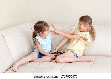 Two Little Mad Angry Girls Sisters Having Fight At Home. Friends Girls Can Not Share Gadget Tablet. Lifestyle Authentic Funny Family Moment Of Siblings Quarrel Life. Kids Bad Behaviour. 