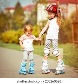 two little sisters to roller skate on the street