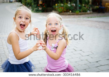 Two little sisters shouting. Selective focus.