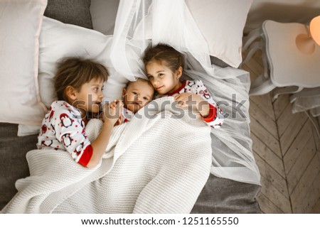 Similar – Little girl embracing doll lying over the bed