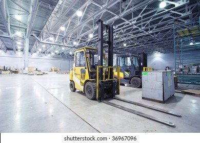 Two loaders in modern storehouse