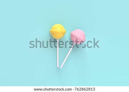 two lolipop yellow and pink on mint blue pastel background.sweet candy concept