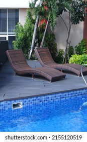 Two Lounge Chairs By The Pool.