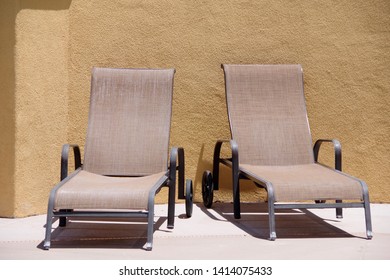 Two Lounge Chairs At A Poolside On A Sunny California Day In May