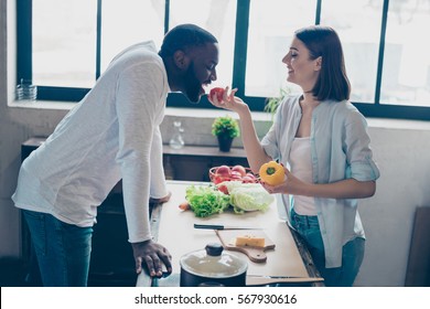 two lovely mixed race people together cooking healthy breakfast. Handsome afro american guy flirting with his  beautiful caucasian girl  in kitchen. - Powered by Shutterstock