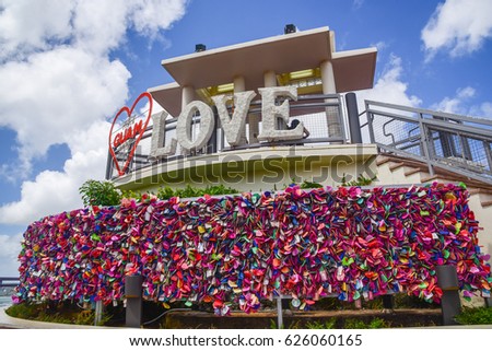 Two lovers point look out view point with Love,GUAM, Red Heart sign: Close up view with many  locks