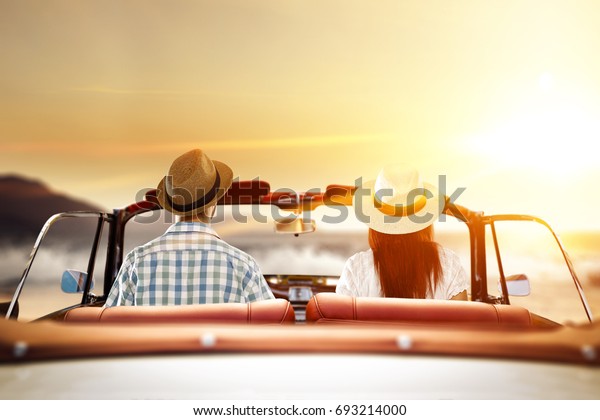 two lovers in\
retro car and summer sunset time\
