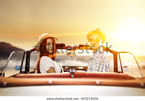 two lovers in\
retro car and summer sunset time\
