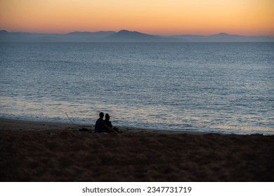 Two lovers watching a sunset