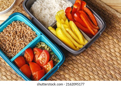 Two Lunch Boxes With Cooked Groats And Cut Vegetables