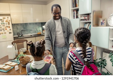 Two Lunchboxes. Loving Father Feeling Memorable Giving Two Lunchboxes For His Daughters Going To School