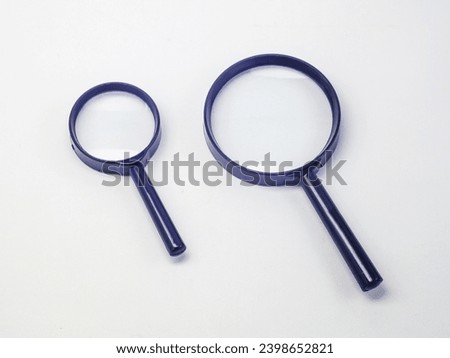two magnifying glasses of different sizes, isolated on a white background