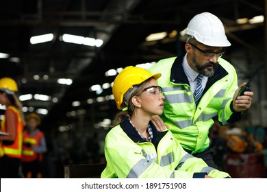 Two maintenance engineers men and women inspect relay protection system with laptop comp. They work a heavy industry manufacturing factory. - Shutterstock ID 1891751908