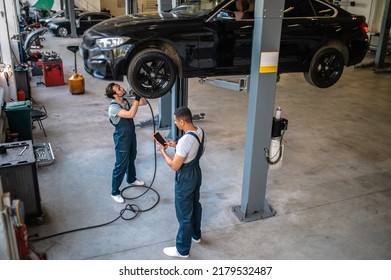 Two maintenance engineers at work in the garage
