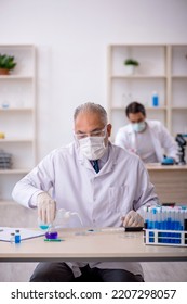 Two Male Chemist Working At The Lab