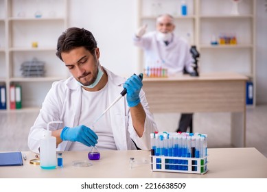 Two Male Chemist Working At The Lab