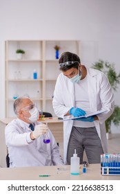 Two Male Chemist Working At The Lab