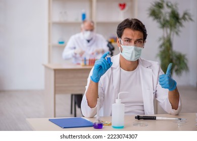 Two Male Chemist Working At The Lab