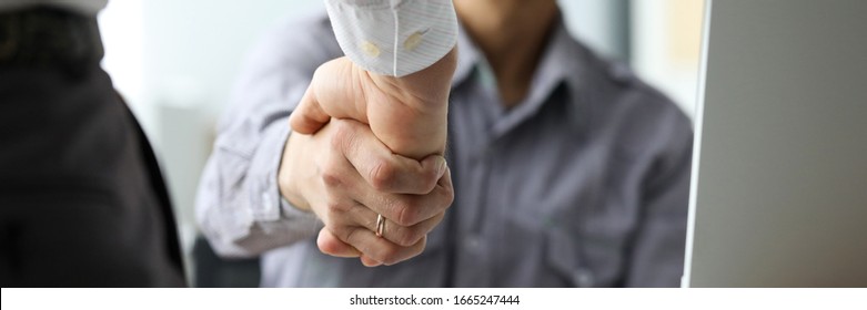 Two male clerks shaking hands at workplace close-up. Symbol of beginning of new positive promising relationship for future opportunities concept - Powered by Shutterstock