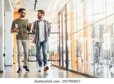 Two male colleagues discussing something on way to work - Powered by Shutterstock