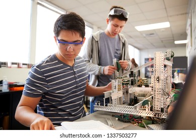 Two Male College Students Building Machine In Science Robotics Or Engineering Class