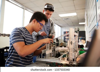 Two Male College Students Building Machine In Science Robotics Or Engineering Class