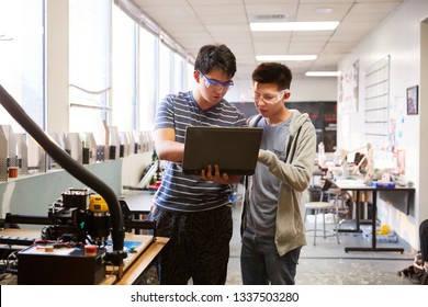 Two Male College Students Using Laptop Computer In Science Robotics Or Engineering Class