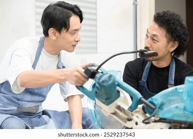 Two male craftsmen working on DIY, cutting wood, making things and shaving Image of carpentry and woodworking shop - Powered by Shutterstock