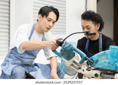 Two male craftsmen working on DIY, cutting wood, making things and shaving Image of carpentry and woodworking shop - Powered by Shutterstock