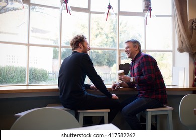  Two Male Friends Meeting In Coffee Shop	