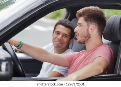 Two Male Friends Relaxing In Car During Road Trip