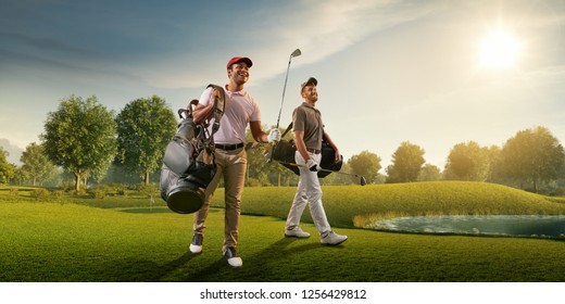 Two male golf players on professional golf course. Smiling golfers walking with golf clubs and golf bags - Powered by Shutterstock