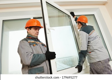 Two Male Industrial Builders Workers At Window Installation