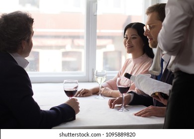 Two male and one female partners having wine before business lunch at luxury restaurant. - Shutterstock ID 1095889820