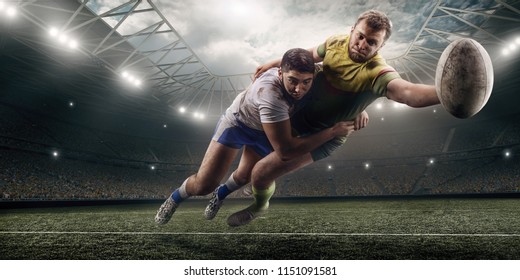 Two male Rugby players fight for the ball in flight on professional rugby stadium