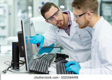 Two Male Scientist Working Together At The Modern Laboratory Using Computer Copyspace Communication Partnership Interns Scrubs Health Medicine Online Researchers Teamwork Biology Immunology Job.