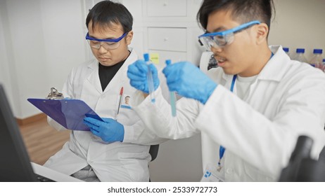 Two male scientists examining specimens in a laboratory, wearing white coats, gloves, and protective eyewear. - Powered by Shutterstock