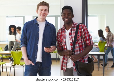 Two Male Students Looking At Mobile Phone In Classroom - Shutterstock ID 296315117