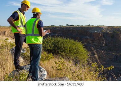 two male surveyors working at mining site - Powered by Shutterstock