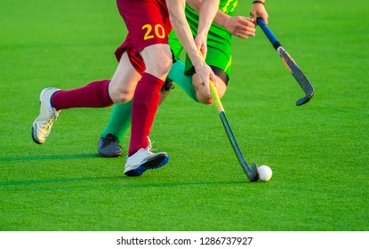 Two man battle for control of ball during field hockey game - Powered by Shutterstock